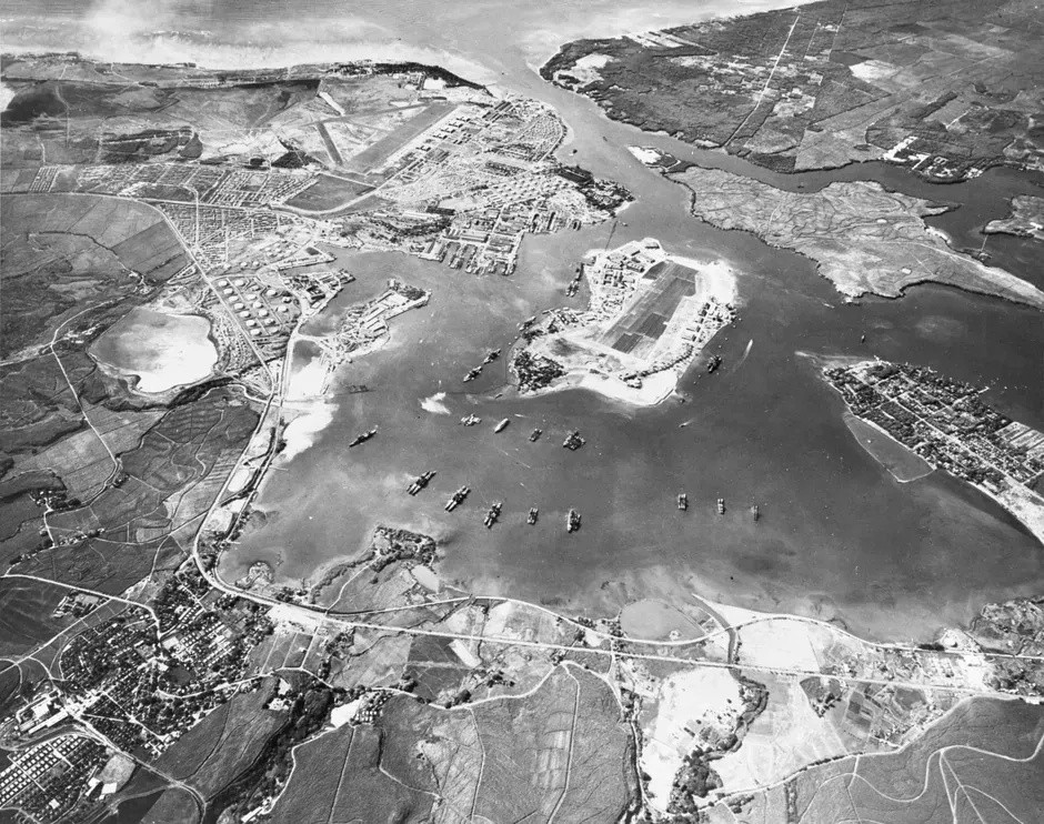 Aerial photograph of the U.S. Naval Operating Base at Pearl Harbor, October 30, 1941 -- five weeks before the Japanese attack. Ford Island and Battleship Row are visible with ships lined up in calm water.
