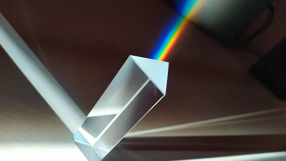 Precision optical lens refracting light into two distinct beams traveling in opposite directions, teal and amber, against a dark background